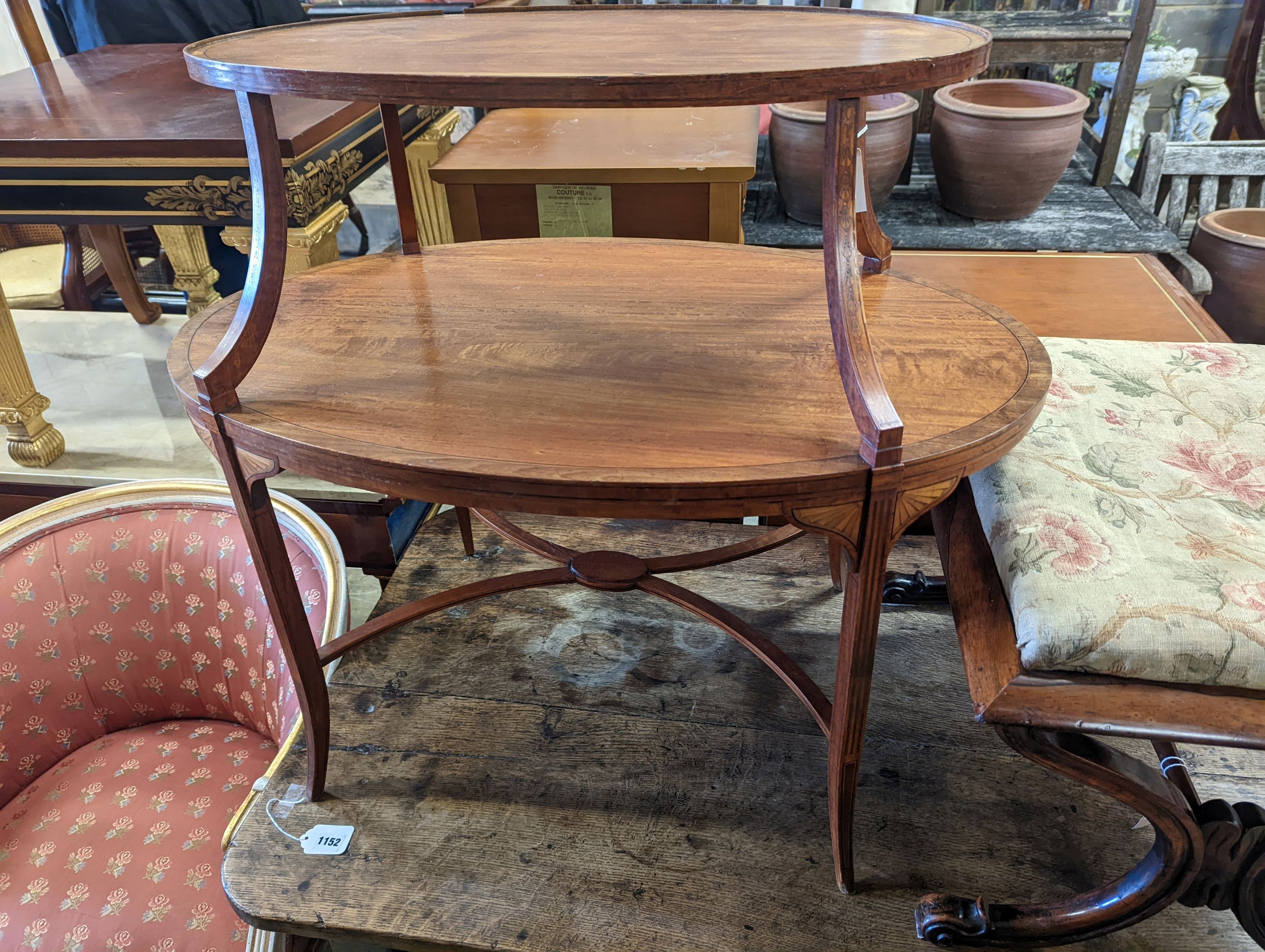 An Edwardian Sheraton revival oval inlaid satinwood two tier etagere, width 89cm, depth 55cm, height 77cm